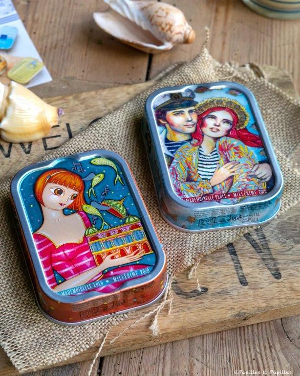 Sardines millésimées de la Perle des Dieux conditionnées à la main dans une jolie boîte métal illustrée par des artistes pour en faire un écrin unique.